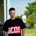 boy in black crew neck t-shirt wearing black framed eyeglasses